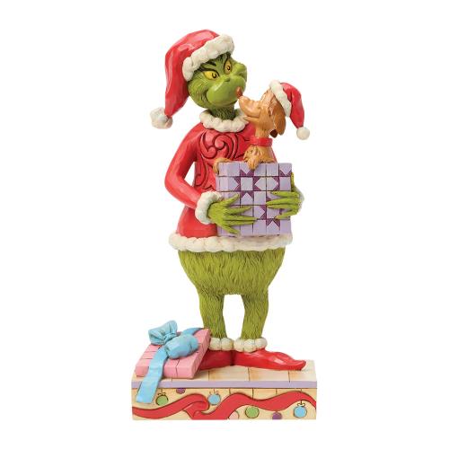 the grinch holding gift with max popping out by jim shore